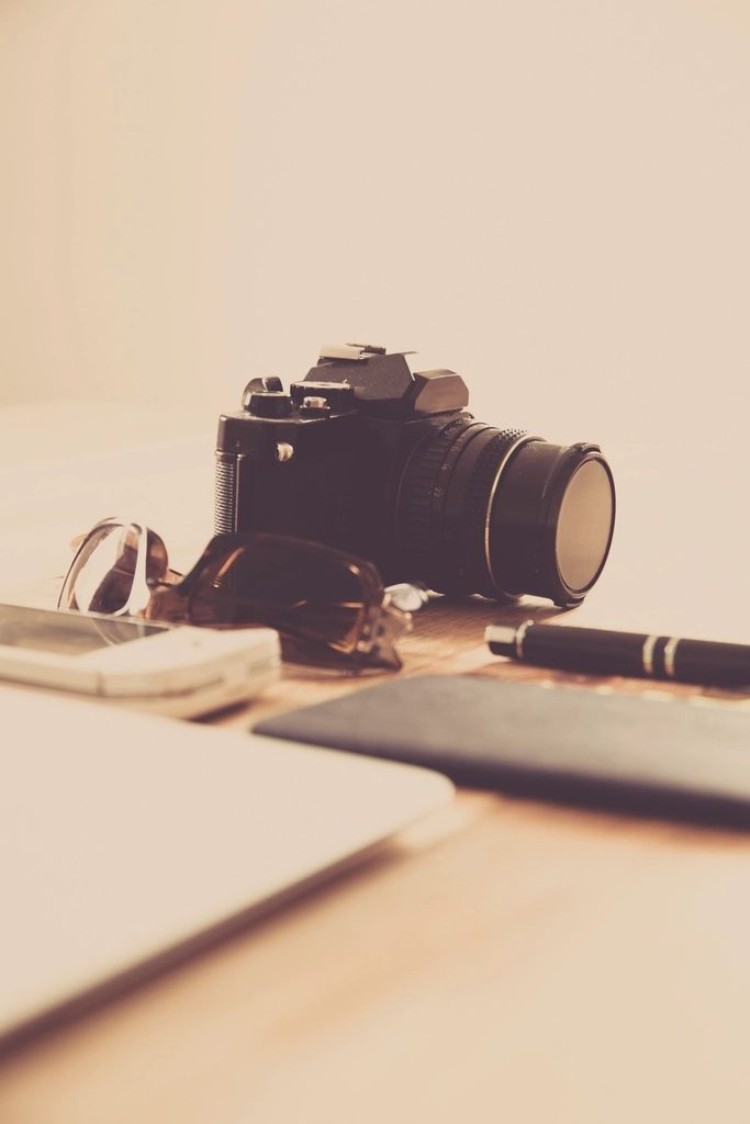 Illustrative photograph of creative desk camera notebook